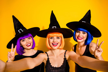 We are positive kind magicians. Close up photo of socialized enthusiastic cheerful excited good ladies having fun taking self picture in colorful hairdo red lips v-sign isolated vivid background