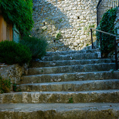 street and stairs of mediterranean village with stone wall