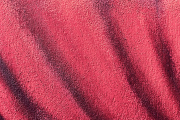 Abstract detail of colored wall. Bright red tone graffiti, scratch, grunge texture. Aerosol design...