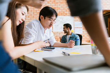 small group of creative startup business brainstorm meeting casual strategy direction together in moden office background