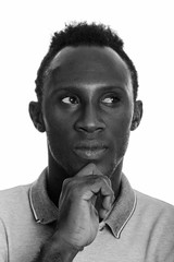 Face of young black African man thinking