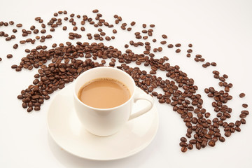 cup of coffee with beans on white background