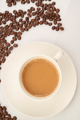 cup of coffee with beans on white background