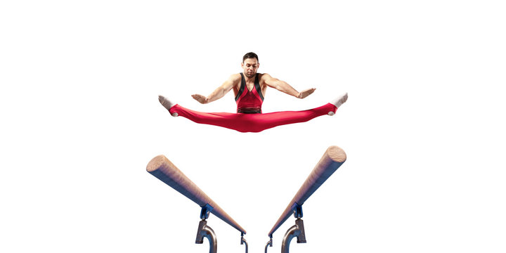 Male athlete doing a complicated exciting trick on parallel bars on white background. Isolated Man perform stunt in bright sports clothes