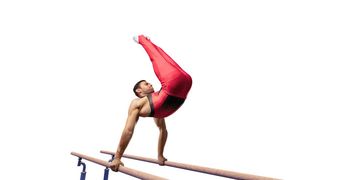 Male athlete doing a complicated exciting trick on parallel bars on white background. Isolated Man perform stunt in bright sports clothes