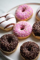 Colorful donuts on marble background with copy space
