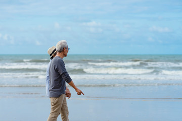 Asian couple senior elder retire resting relax walking running at the beach.Honeymoon family together happiness people lifestyle.Mature couples relax at the seaside on holiday.