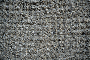 Texture of an old cracked concrete wall. Background image of a worn gray concrete surface