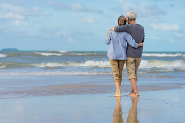 Asian couple senior elder retire resting relax walking running at the beach.Honeymoon family together happiness people lifestyle.Mature couples relax at the seaside on holiday.