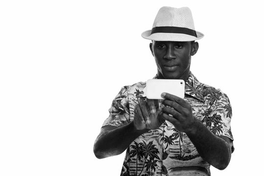 Young black African man taking picture with mobile phone