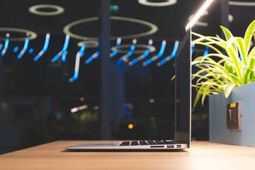 Close up Laptop on desk with big window in modern office.