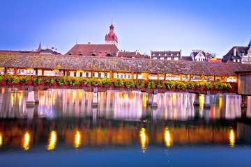 Kapellbrucke historic wooden bridge in Luzern and waterfront landmarks dawn view
