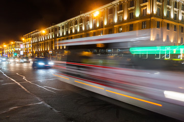 Fototapeta na wymiar Motion blurred minibus on the avenue in the evening.