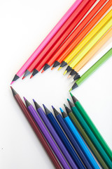 love of drawing. colored pencils laid out in the shape of a heart