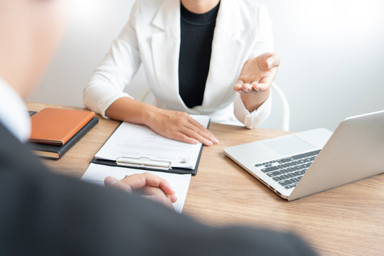 Business consulting candidate employee in suit looking skeptical reading a resume, hr speaking at job interview and recruitment concept.