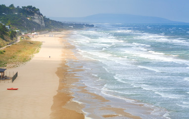 Beach and sea in south italy on a windy day with waves and sun, travel, holiday concept 