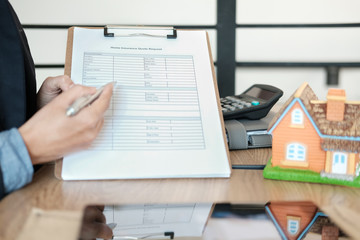 businessman showing home insurance quote request