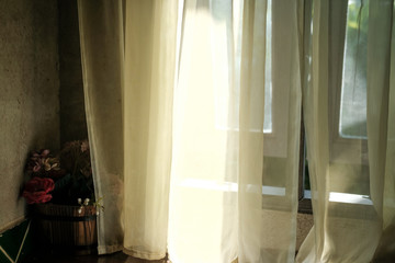 Fototapeta na wymiar light on yellow see through sheer window curtain