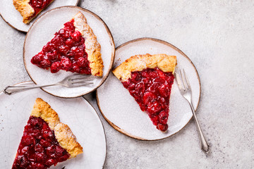 Bakery products. Summer pie with berries. Galeta with cherries sprinkled with powdered sugar.