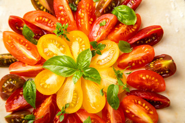 Summer cake with cherry tomatoes, brie cheese and basil. Baking dough with vegetables, greens.