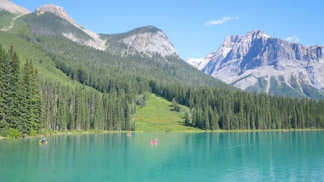 Natural landscape view of Emerald Lake,Yoho National Park,Alberta,Canada with some canoe in lake with clear bule sky and rockie moutain range in summer daytime