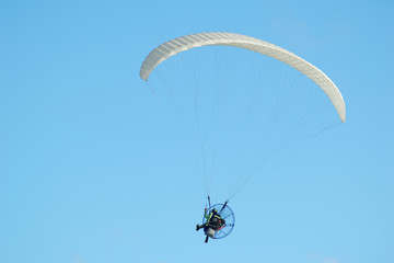 Paraglider in the blue sky