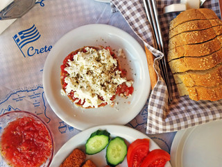 Traditional Cretan dish with tomatoes and cheese Dakos or ntakos.