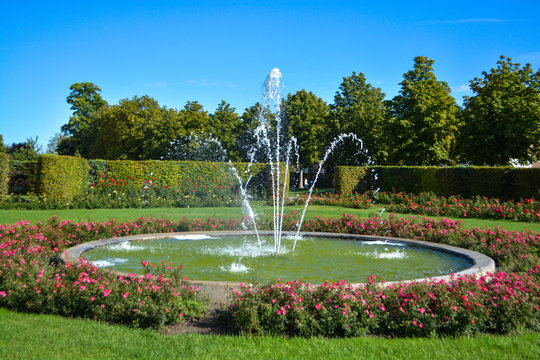 Water fountain with baroque garden in the background