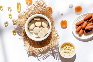 Nutritional supplements and vitamins on white background. Medicines for health support. Pills and supplements for people health.