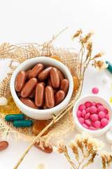 Nutritional supplements and vitamins on white background. Medicines for health support. Pills and supplements for people health.