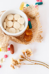 Nutritional supplements and vitamins on white background. Medicines for health support. Pills and supplements for people health.