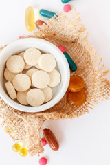 Nutritional supplements and vitamins on white background. Medicines for health support. Pills and supplements for people health.