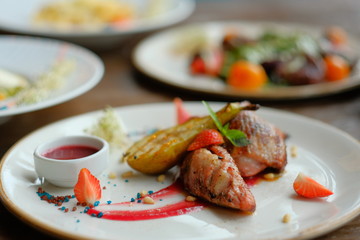 Delicious dish with pear, strawberries sauce.