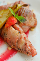 Delicious dish with pear, strawberries sauce.