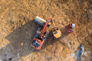 Aerial view over heavy machinery on a building construction site