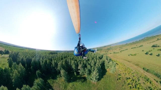 Paragliding tandem flying together with a paraplane.