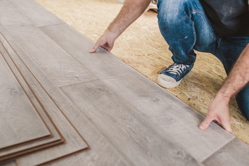 Caucasian master skillfully and professionally lay laminate