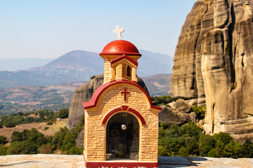 Monastery Meteora Greece. Stunning  panoramic landscape. View of mountains and green forest against epic blue sky with clouds. UNESCO heritage object.