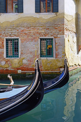 Fototapeta na wymiar A gondola on the aqua green water of a Venice canal in winter