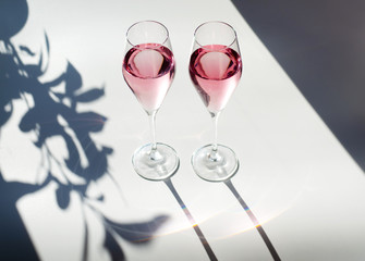 Glasses of pink wine. Beautiful photo with bright light.
