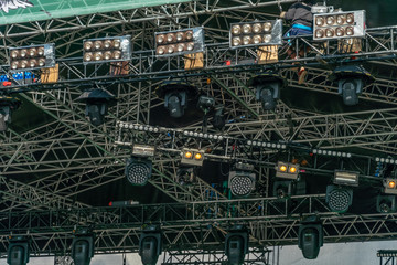 Preparation of stage lighting at the concert. A man adjusts the lighting for the concert