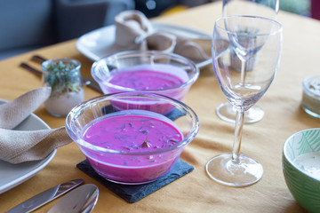 Fototapeta na wymiar Traditional Polish cold soup - chlodnik served during Easter celebration. Delicious local dish made with beetroots and buttermilk.