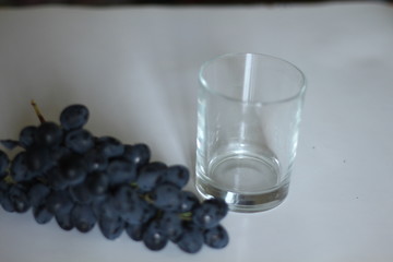 Wine. Red wine pouring in wine glass over white background. Rose wine pour from the bottle