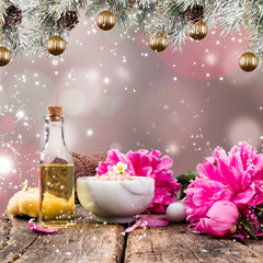 Christmas Spa concept. Gift. Massage, towel and other thing. Holiday blur background and balls. 