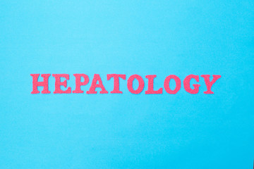 Fototapeta na wymiar The word hepatology from red letters on a blue background. The concept of the section of medicine dealing with the disease of the liver and biliary tract, background
