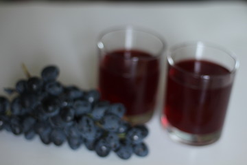 Wine. Red wine pouring in wine glass over white background. Rose wine pour from the bottle