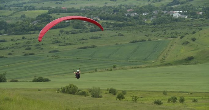Person flying over beautiful countryside area over green valley, enjoying astonishing landscape