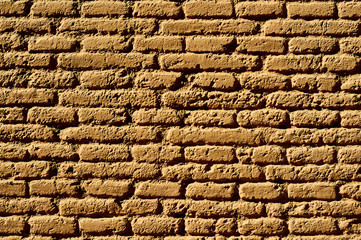 An orange brick wall background.