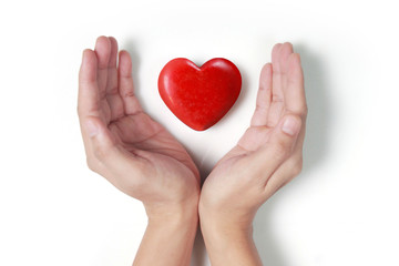 Hands holding  red heart, heart health, and donation concepts...