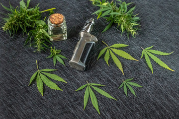 Vape CBD or THC, Vaping Marijuana and Hemp. Against a Dark Background